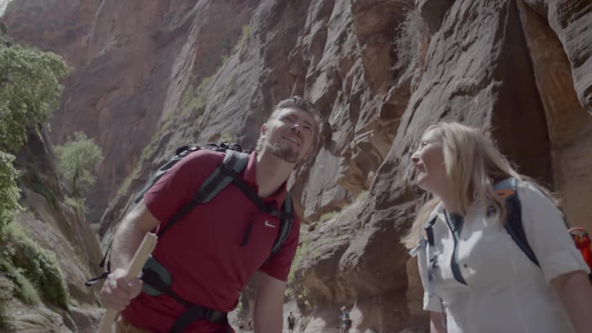 A man and woman are hiking outdoors