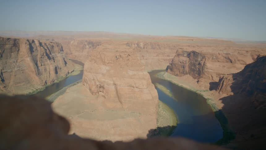 A river surrounds the rock formation
