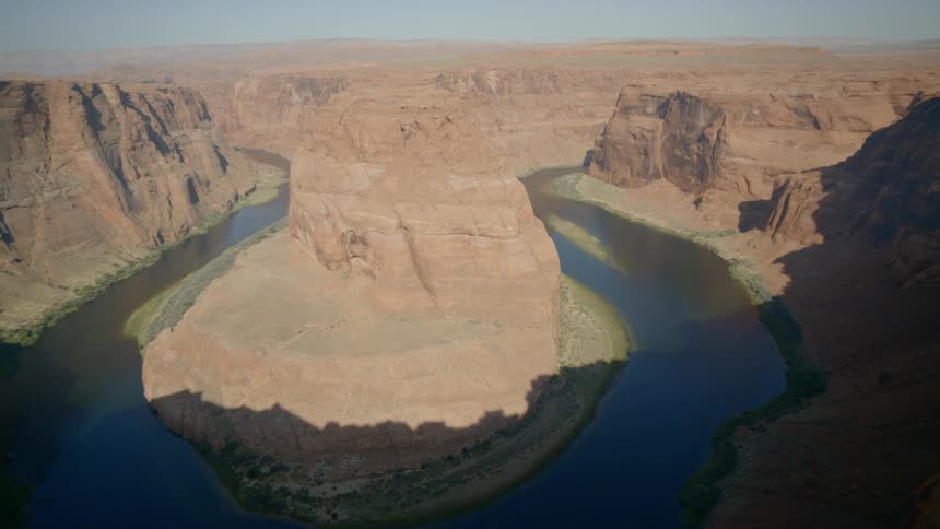 A river forms a circle shape in the bottom of a canyon