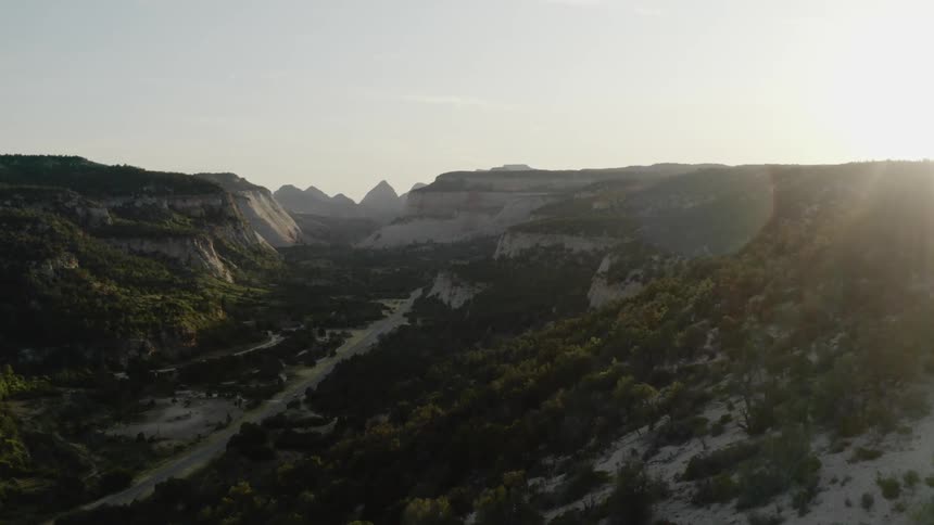 Plant covered hills leading to a mountain range