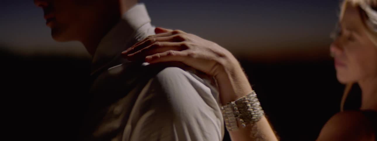 A woman walks around a man