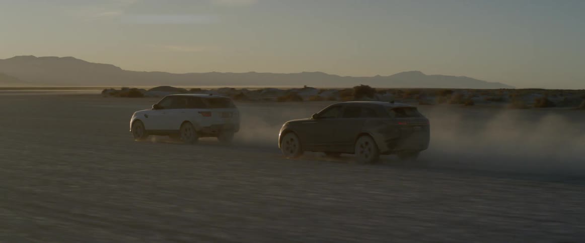 Two vehicles drive off road at sundown