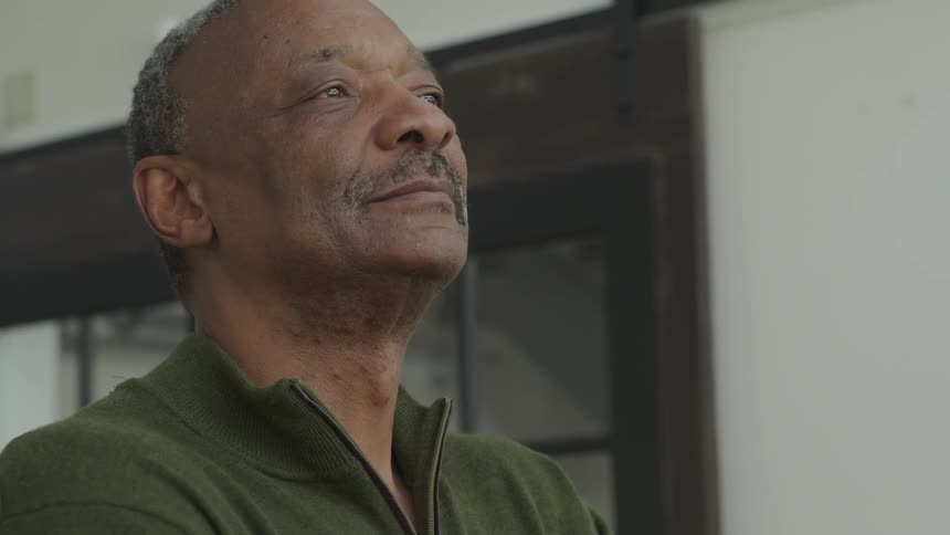 A man looks pleased while looking at something