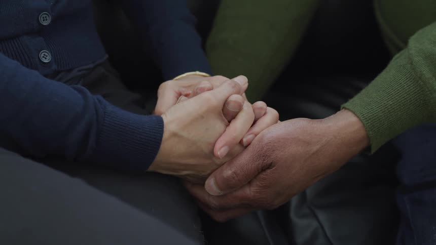 Close up of mixed race couple holding hands