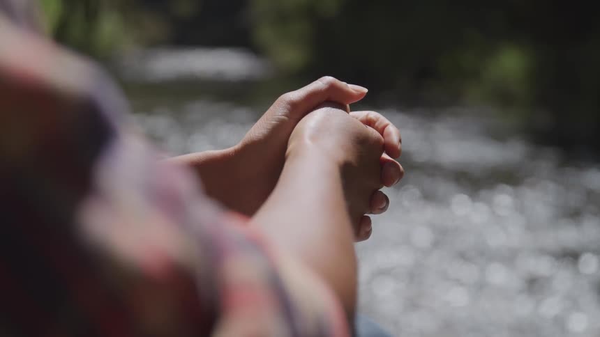 A man sit near a river
