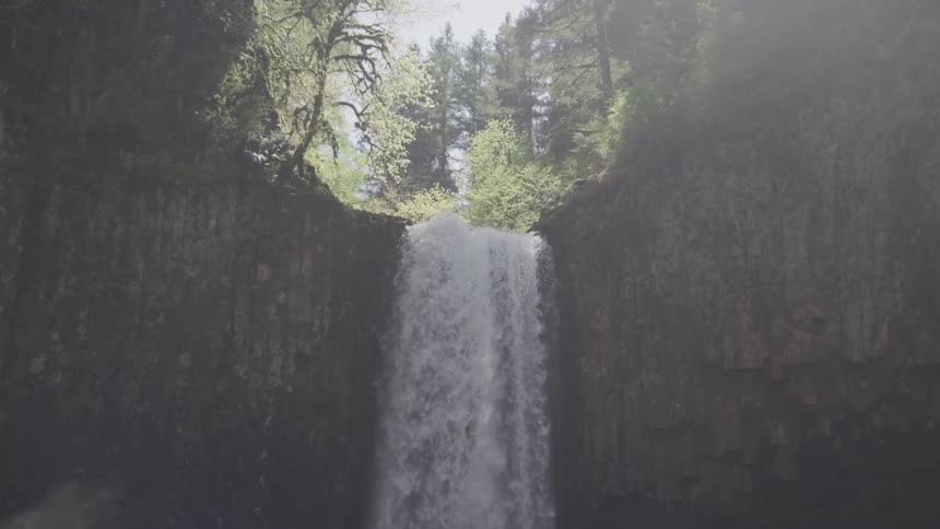 A waterfall pours down the rocks