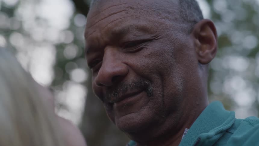 An older man looking at a child