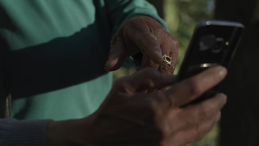 An old man try to use smartphone