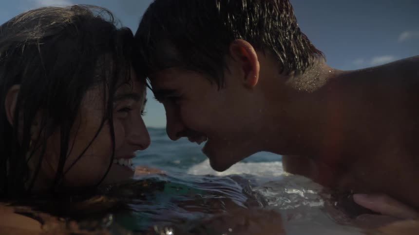 A couple kissing in the middle of the sea