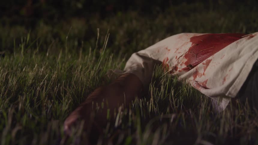 Static shot of a dead body at a crime scene
