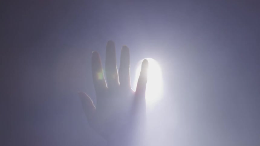 A hand covering a light