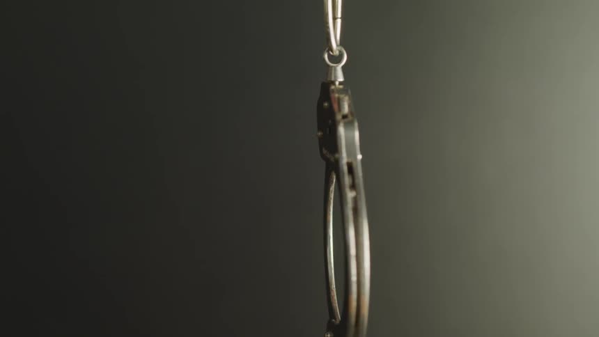 Handcuffs drop down from above
