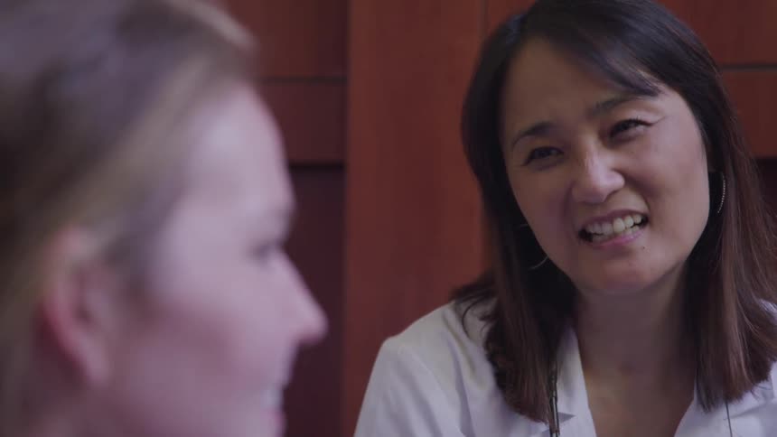 Doctor talking to patient in office