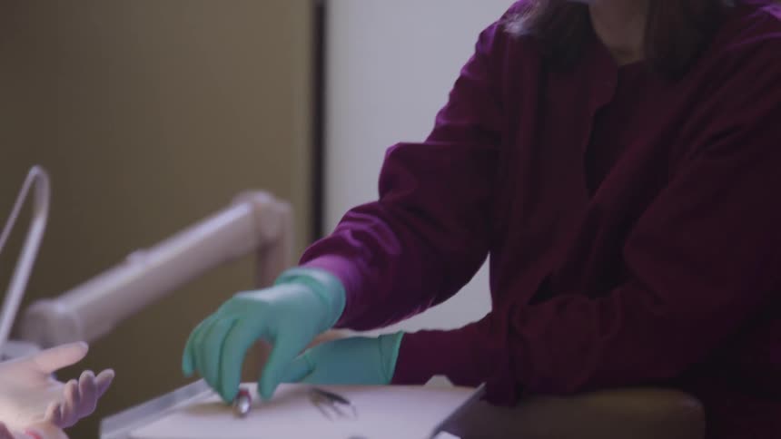 Medical professionals pass instruments to each other during a procedure