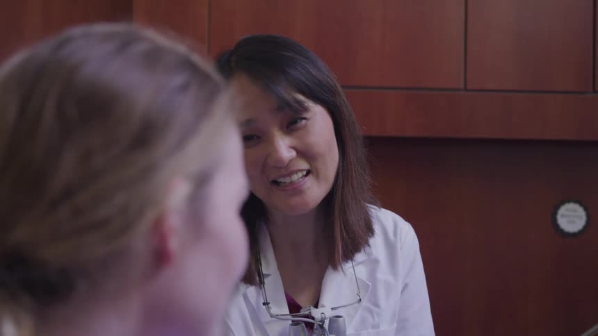 A doctor talking happily with a woman