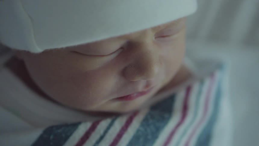 A tiny newborn baby sleeps