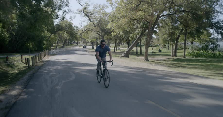 A man riding a racing bike on the streets