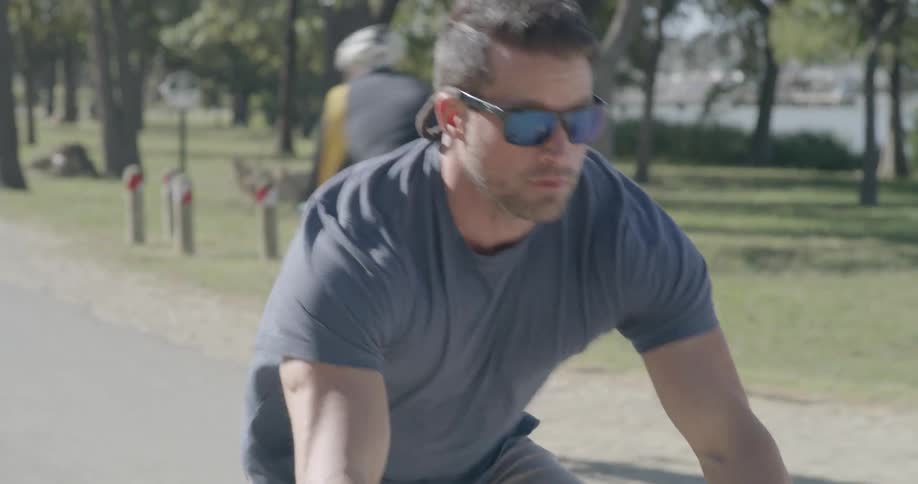 A man rides his bike down the path