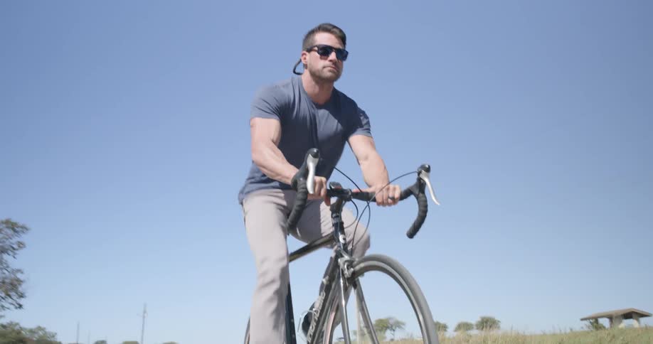 Man riding a bike on the road in countryside