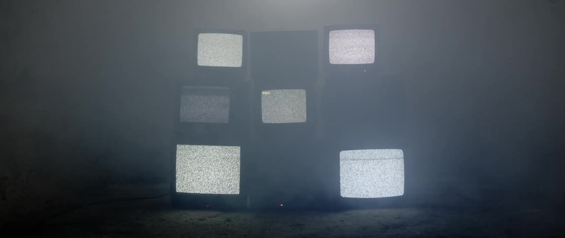 Televisions stacked three by three and turned on in pattern