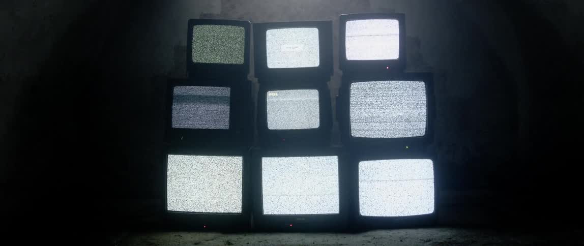 Televisions without a signal are stacked from largest to smallest on top