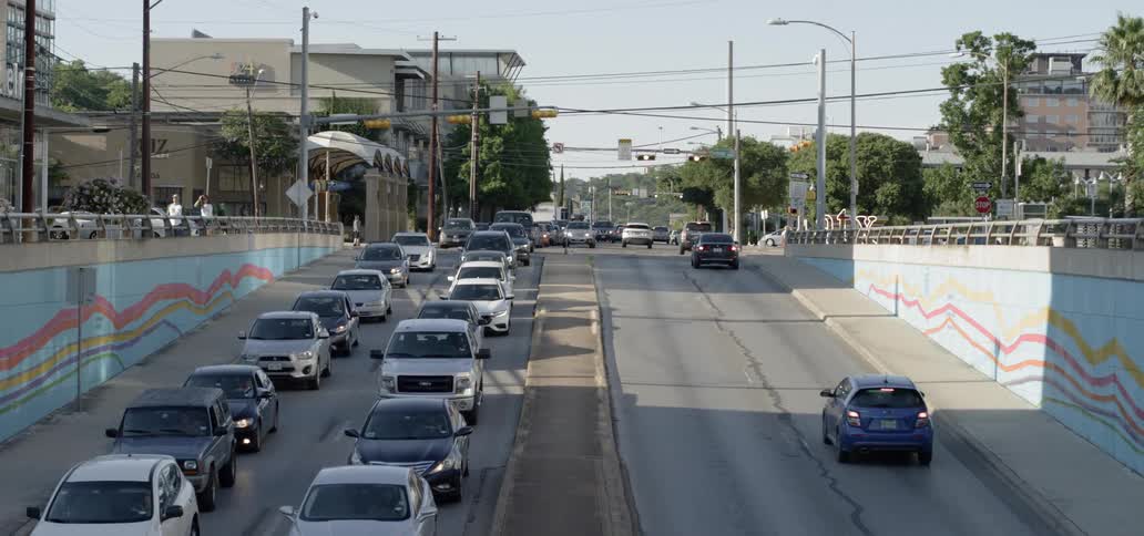 Cars driving down a city street