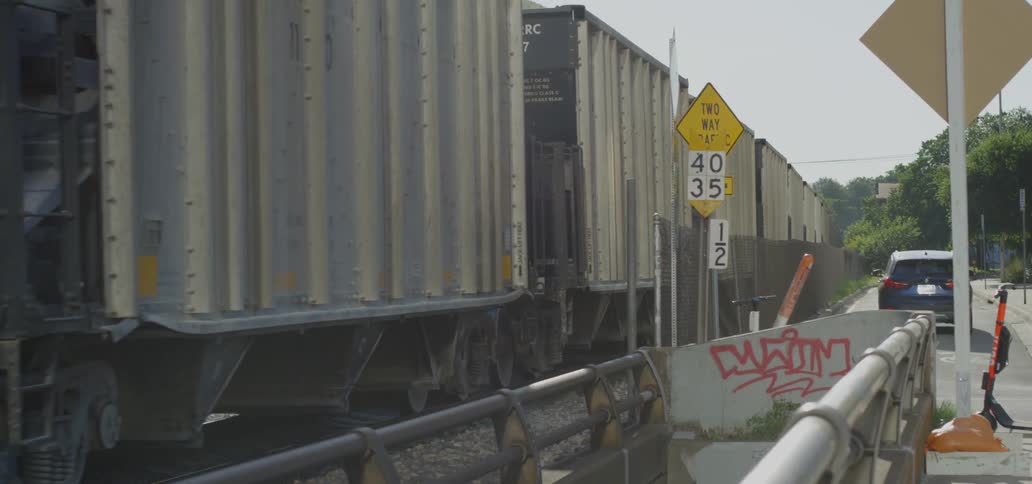 A car is driving besides a train