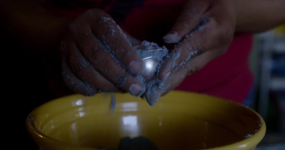 A young child plays in sand