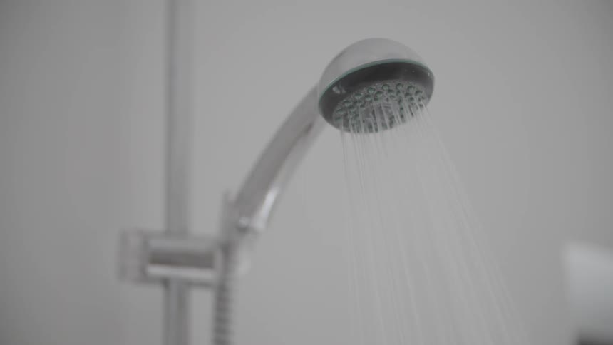 Water sprays out of a shower chrome head