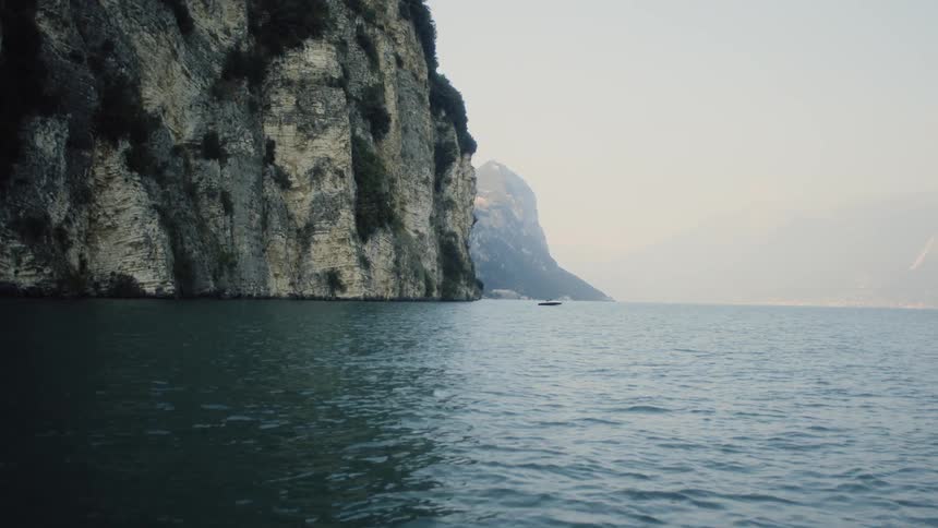 Waves are moving in the water towards the cliff