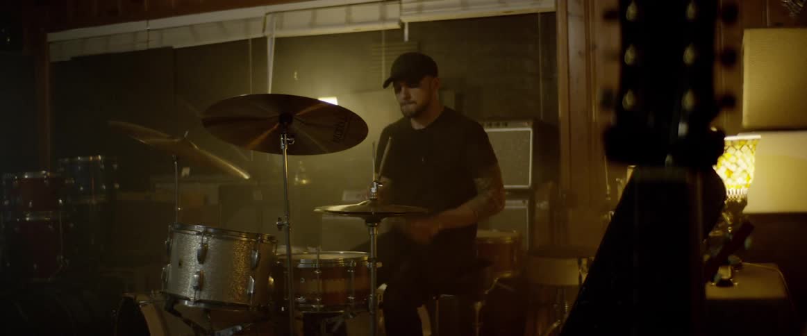 A drummer playing drum at the gig
