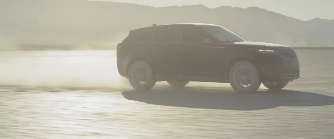 Two range rover sports on the salt flats kicking up dust