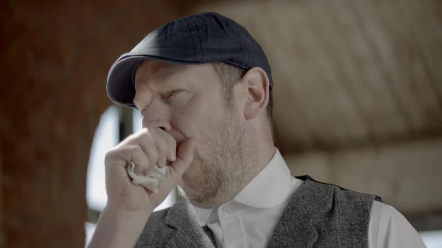 An artist coughing