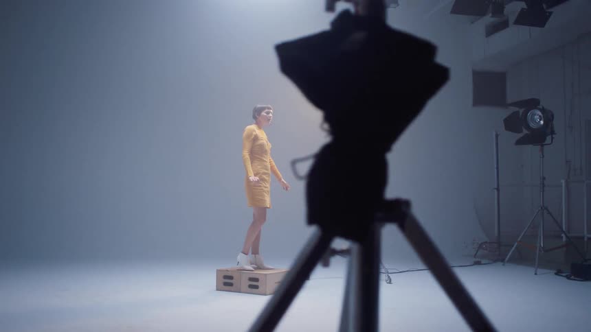 A model stands on a step and poses