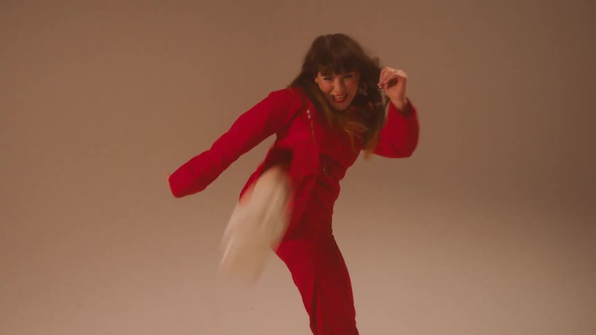 A young woman kick boxes