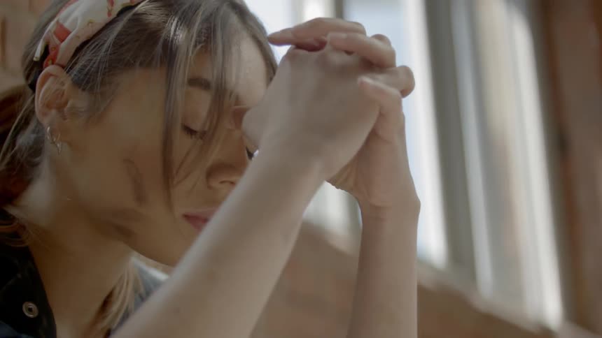 A woman is leaning forward on her hands