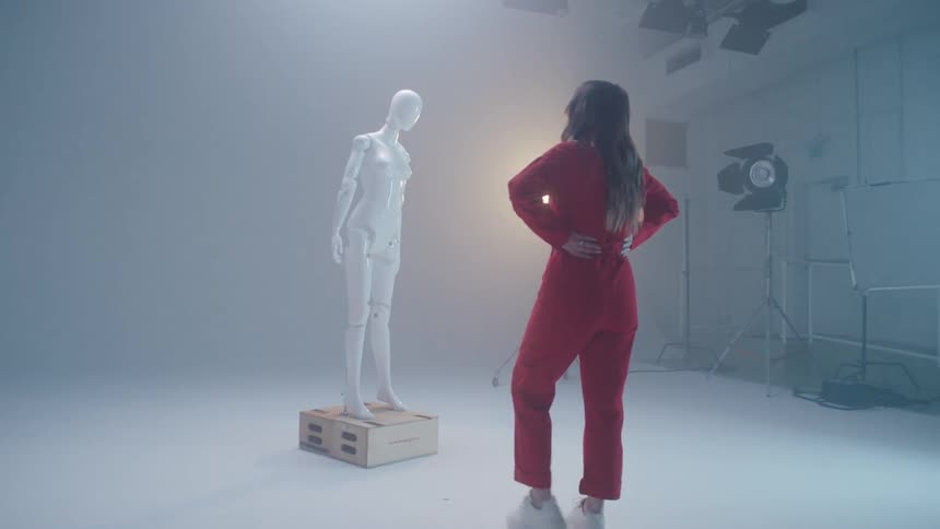 A woman looking at a statue in a photoshoot
