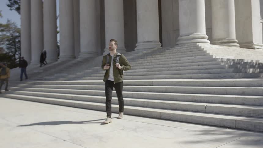 A man is walking down some steps