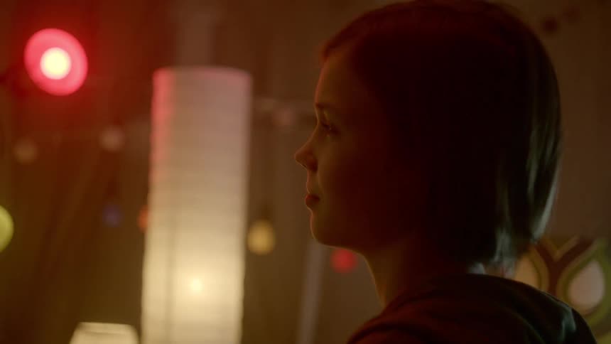 A girl dances in place in a room full of lights