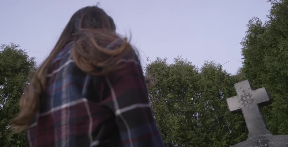 A person visiting a grave site