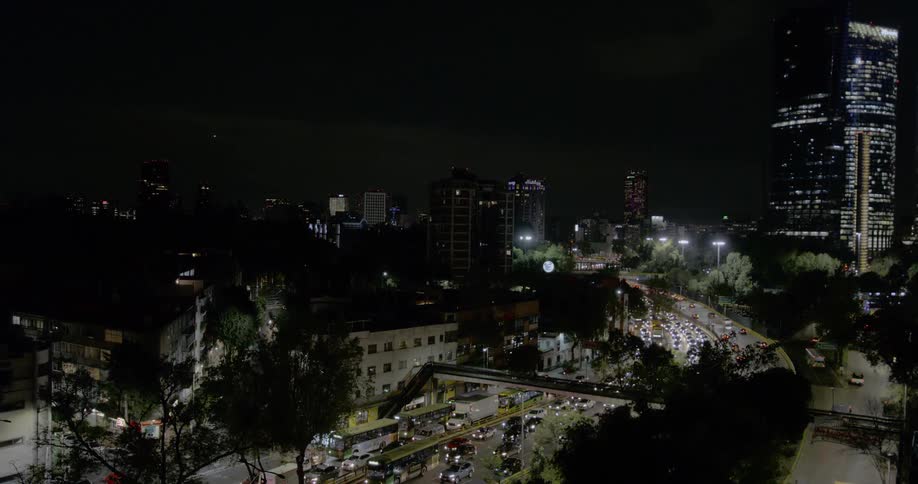 A city at night with buildings streets and vehicles