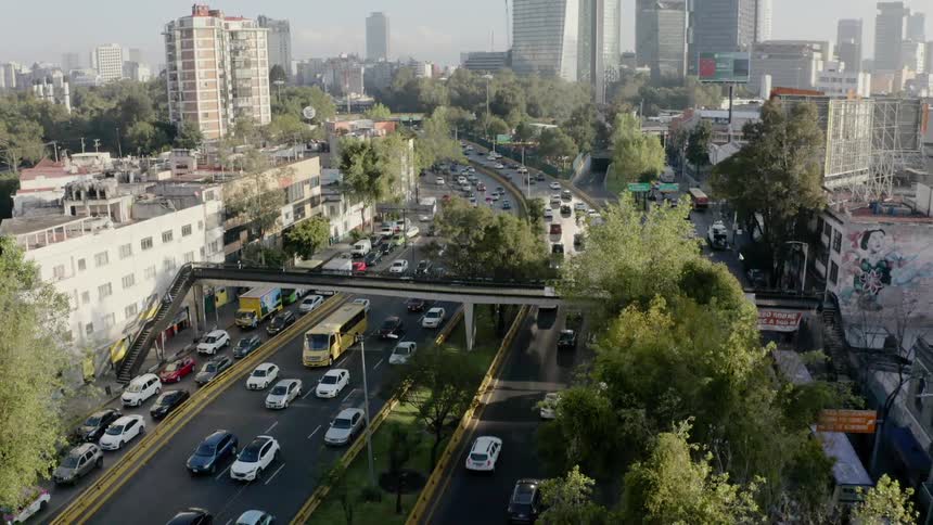 Pedestrian bridge crosses over traffic filled freeway in downtown