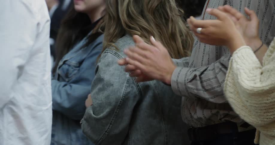 A crowd is clapping their hands