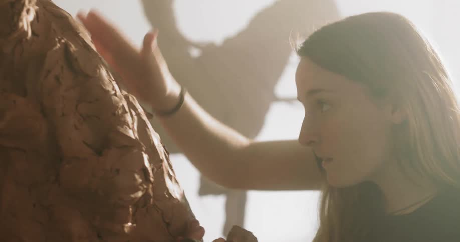 Woman creates a clay horse