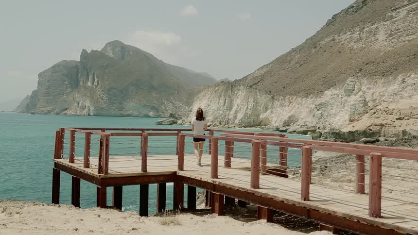 A woman walks on the dock