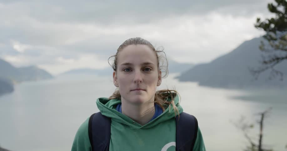 A woman stares at the camera