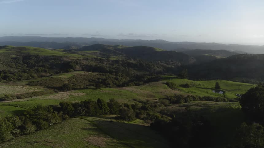 Rolling hills leading out of a mountain range