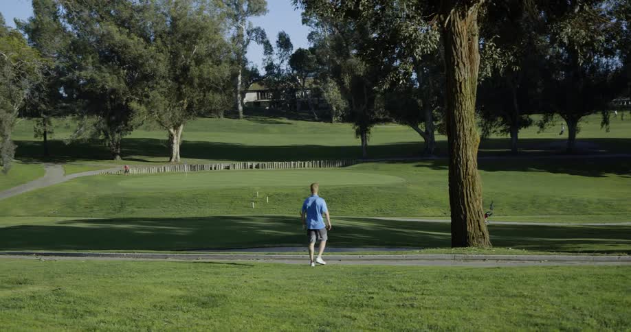 A man walks through a golf course
