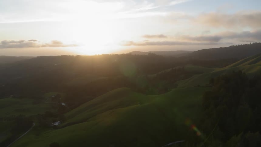 Landscape of green hills at sunset