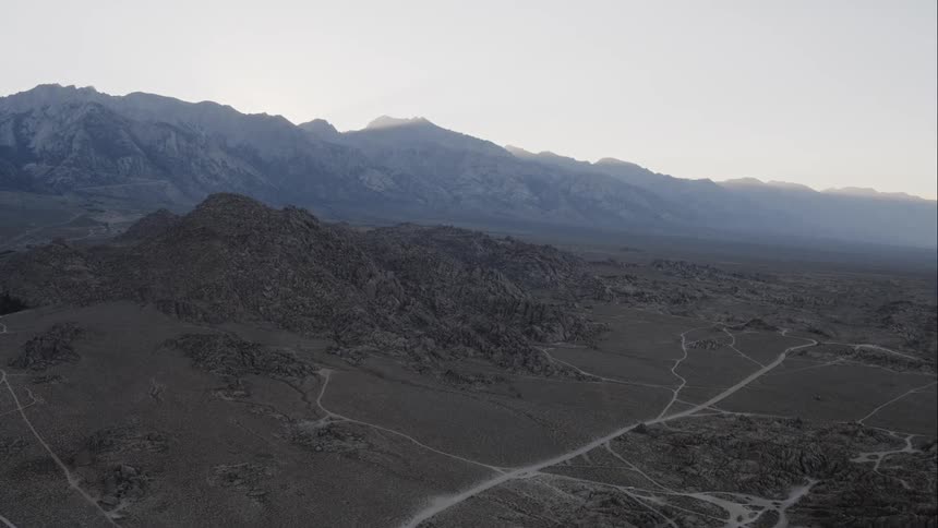 Dirt roads track across a barren and rocky terrain